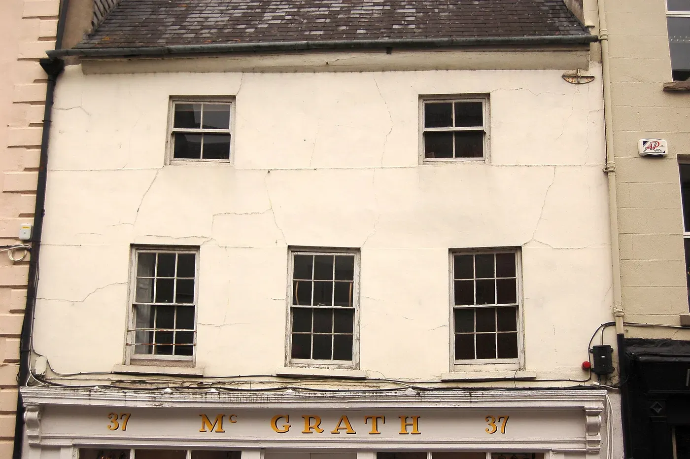 A period timber sash window in a brick facade, the meeting rail and stiles visible